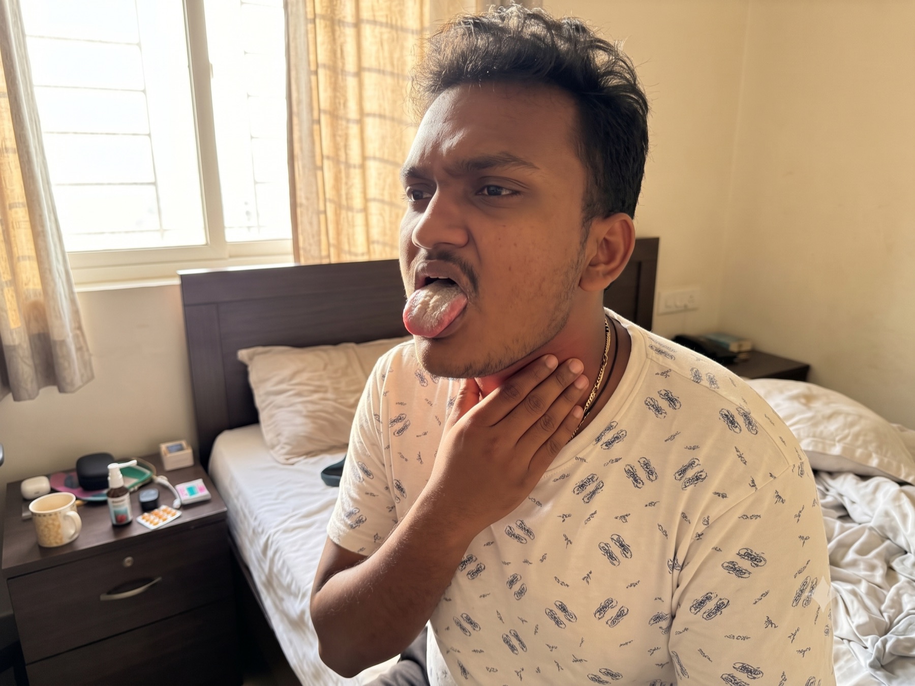 Man checking a dry mouth and sore throat after waking