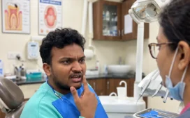 Patient discussing pain and bleeding in one gum spot with a dentist