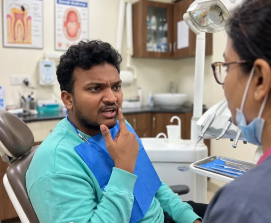 Patient discussing pain and bleeding in one gum spot with a dentist